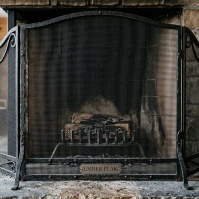 Black steel mesh fireplace screen with Ember Peak base plate