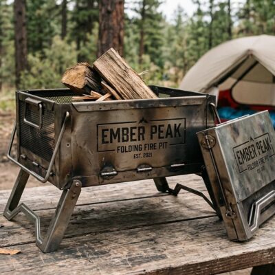 Ember Peak folding portable fire pit with stamped brand at a campsite